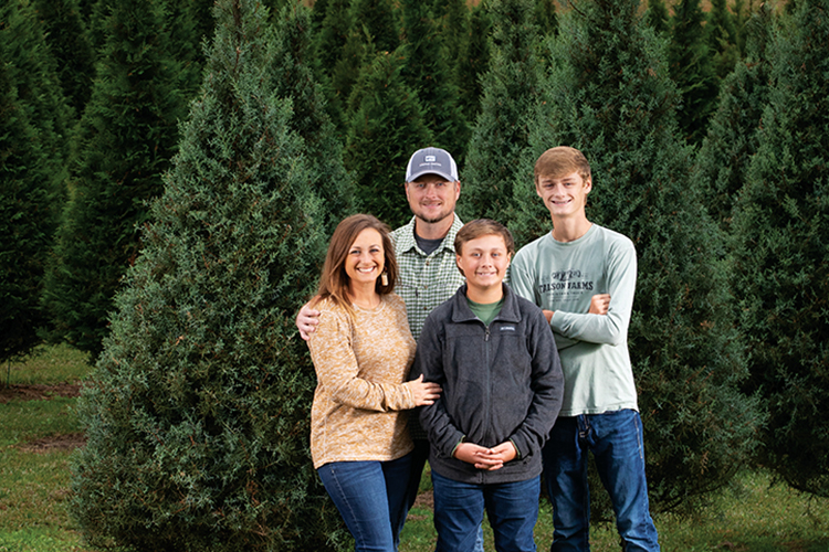 Brittany and Aaron Anderson with the sons Brock and Bruntlee at their Christmas tree farm, Talson Farms, in Laurel.